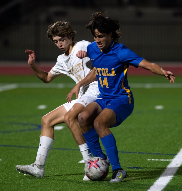 John Carroll's Jacob Gensel, left, and Loyola Blakefield's Mason Cook fight for the ball in the MIAA A boys soccer championship on Sunday, Nov. 5, 2023 at Under Armour Stadium at The House in Baltimore. Loyola Blakefield won 3-1.