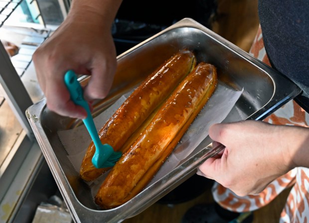 Maggie Ramirez-McGraw, of Get Baked Food Trolley, makes Fresh Blue Crab & Cheese stuffed Pretzel and Nutella stuffed Pretzel rolls at the 2024 Maryland State Fair. (Kenneth K. Lam/Staff)