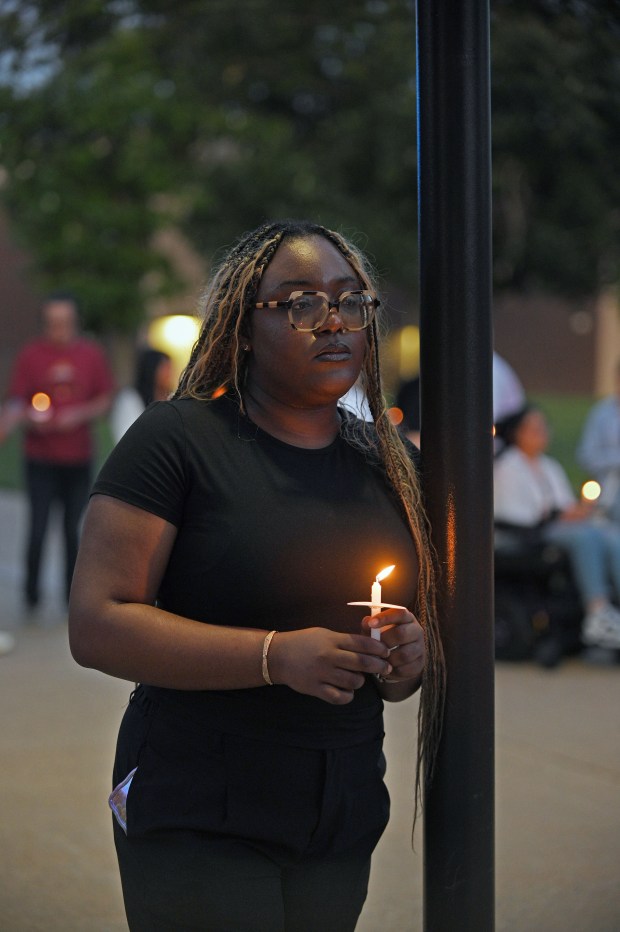 CCBC-Essex student Evita Nwachukwu holds a candle during vigil for Andrea Rodriguez Avila, who was killed in the Rice University shooting. Andrea Rodriguez Avila was the first student Nwachukwu met on CCBC-Essex campus in 2022 and they became good friends. (Kenneth K. Lam/Staff)